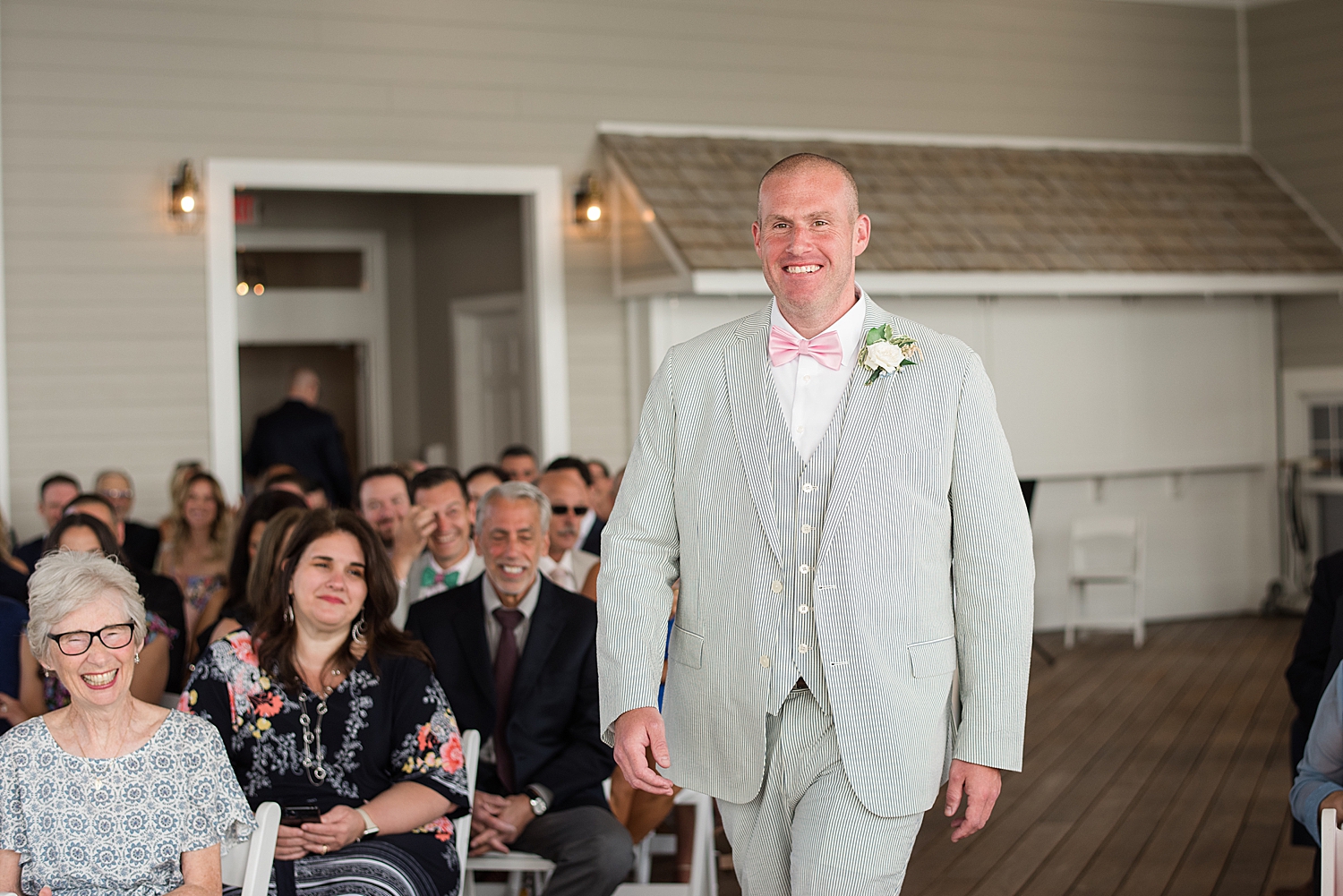 groom walks down the aisle