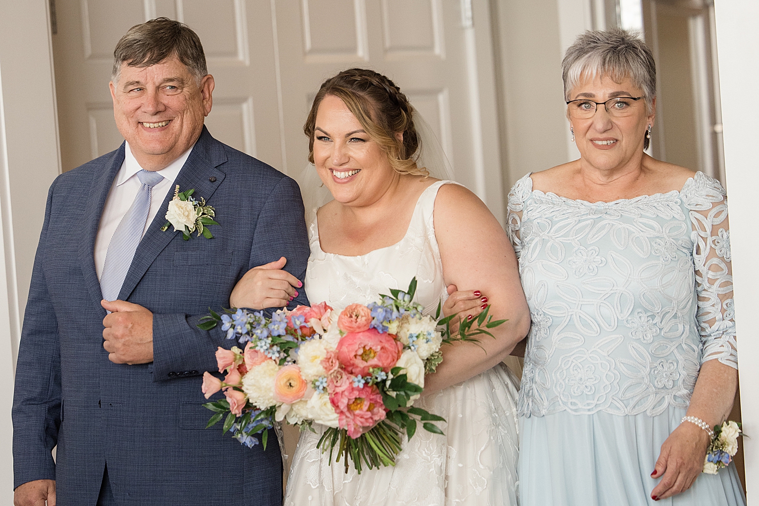 bride walks down aisle with parents