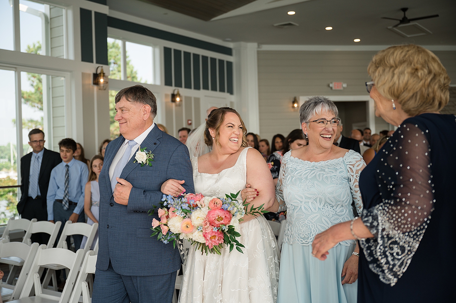 bride walks down aisle with parents