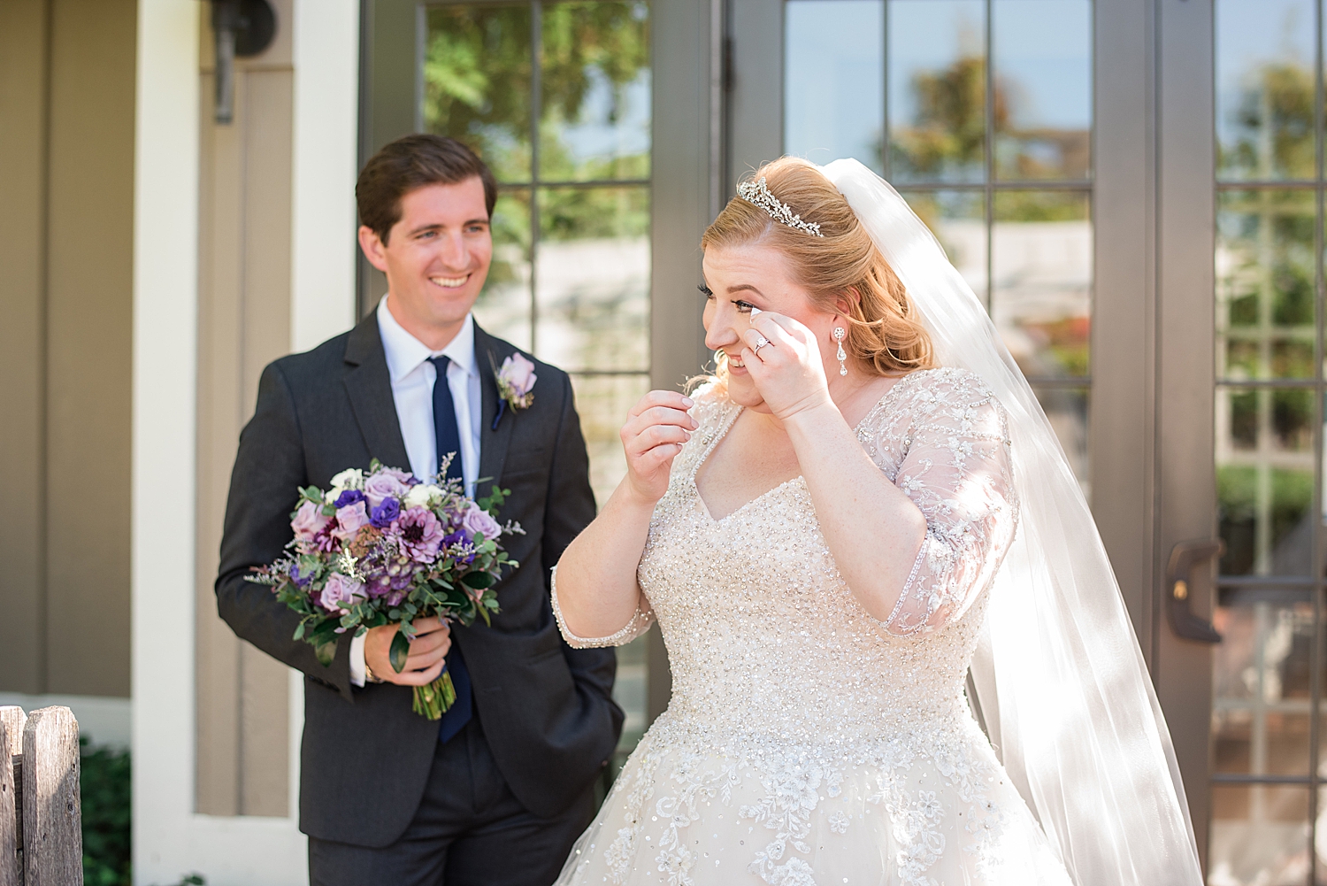 bride wiping tears after first look