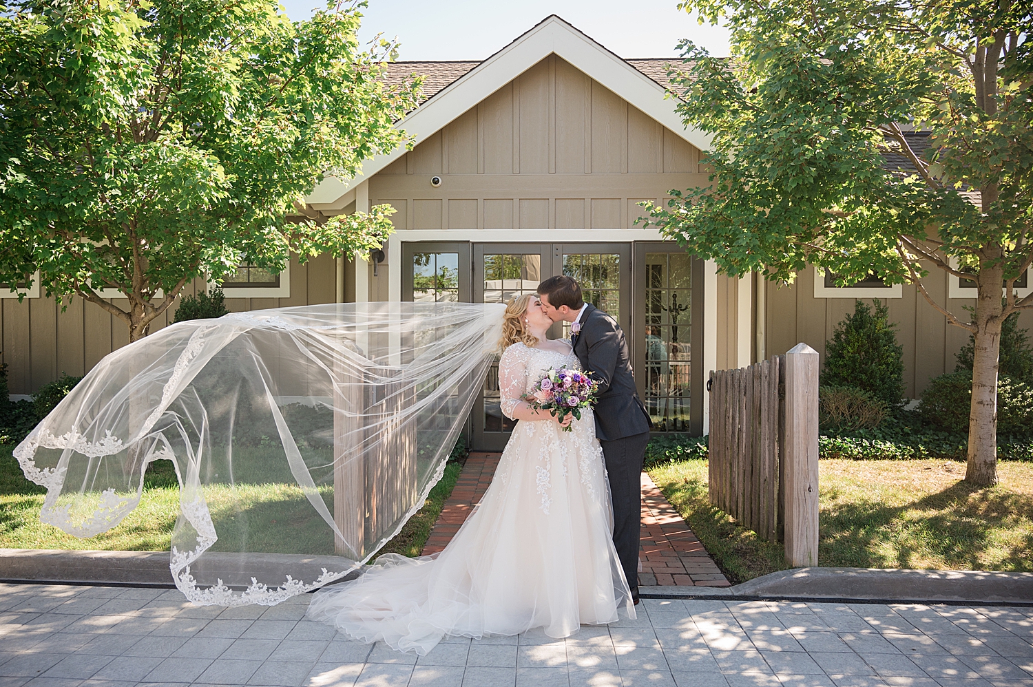 bride and groom portrait in chesapeake bay inn courtyard veil toss