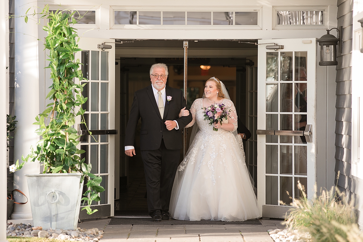 bride walks down the aisle with dad