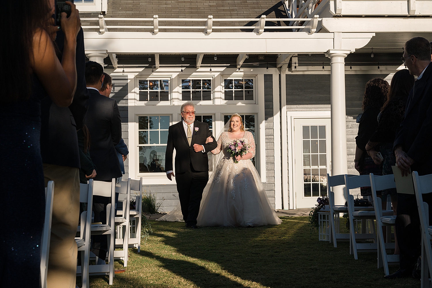 bride walks down the aisle with dad