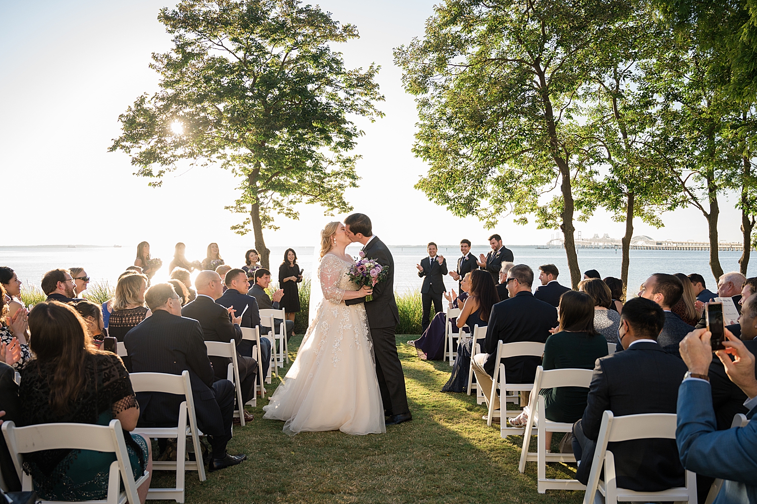 bride and groom kiss in aisle during recessional