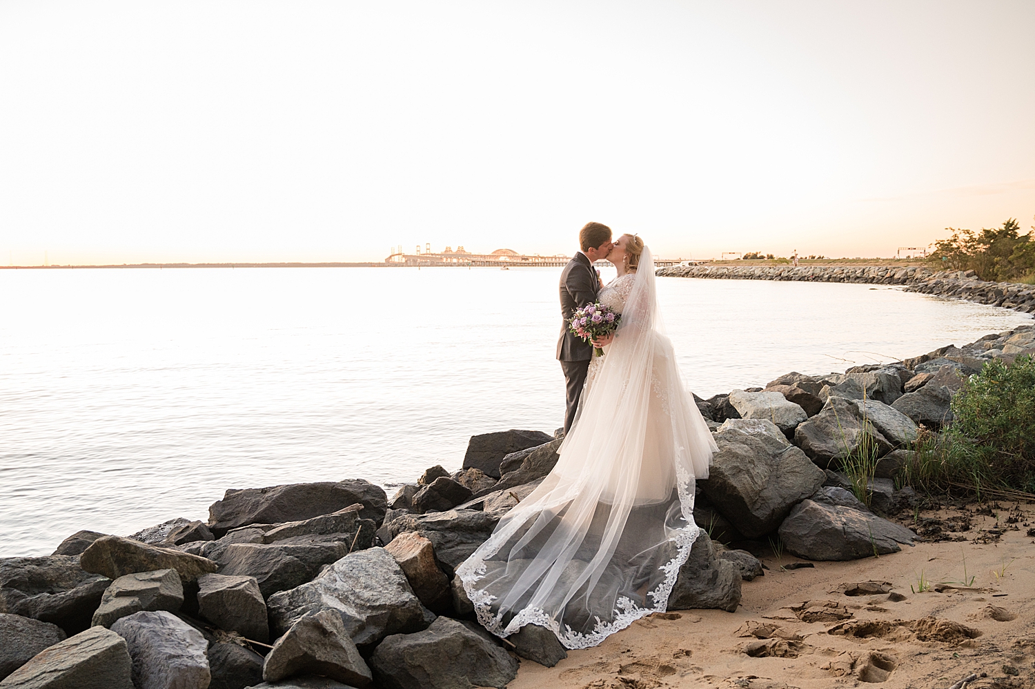 bride and groom portrait on beach at sunset rocks