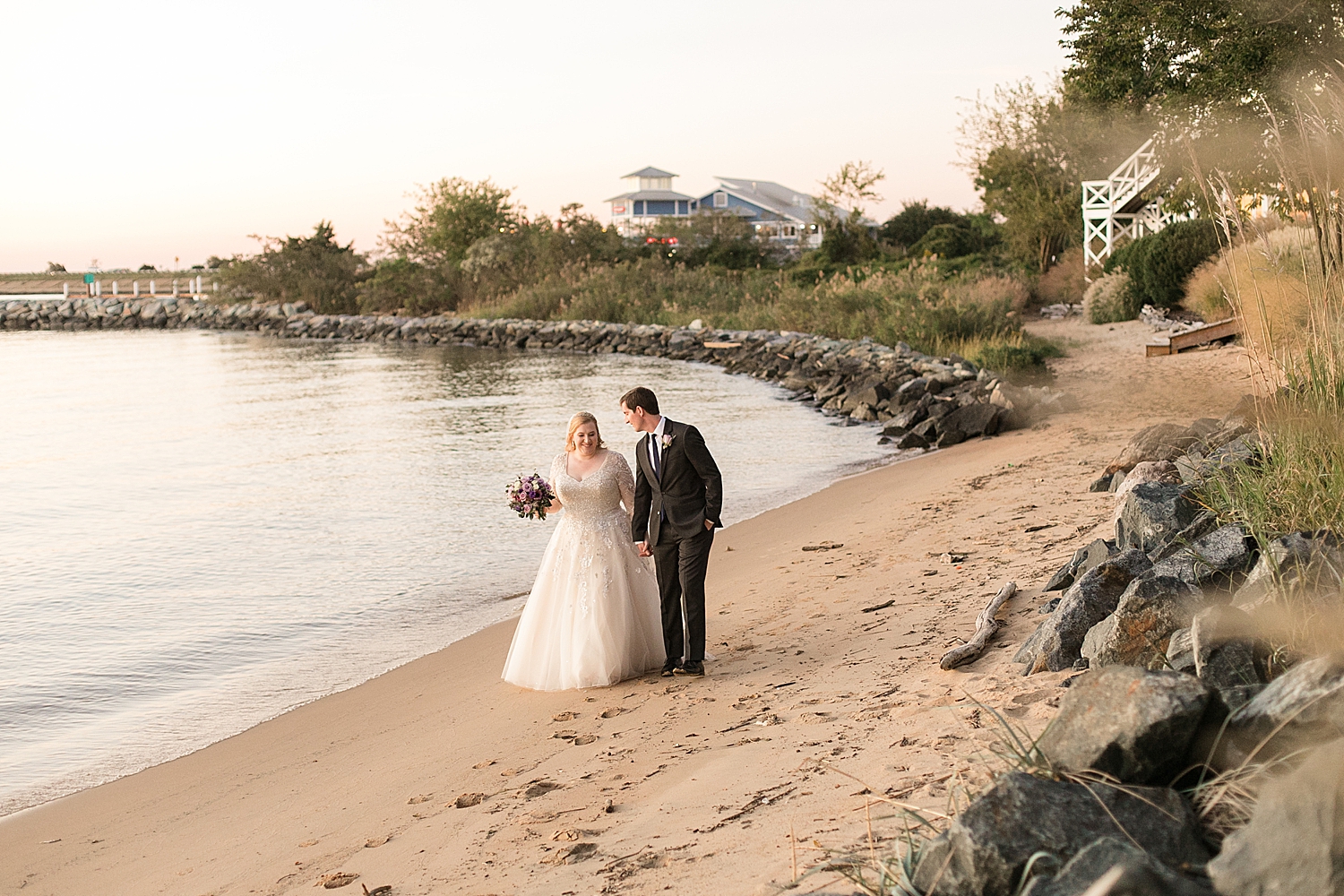 bride and groom portrait on beach at sunset walking