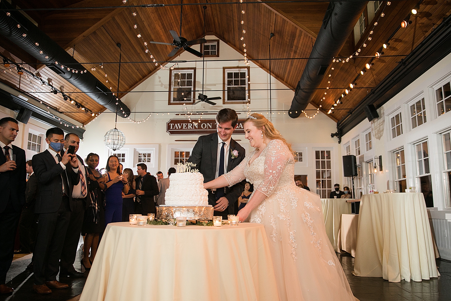 bride and groom cutting cake in tavern ballroom