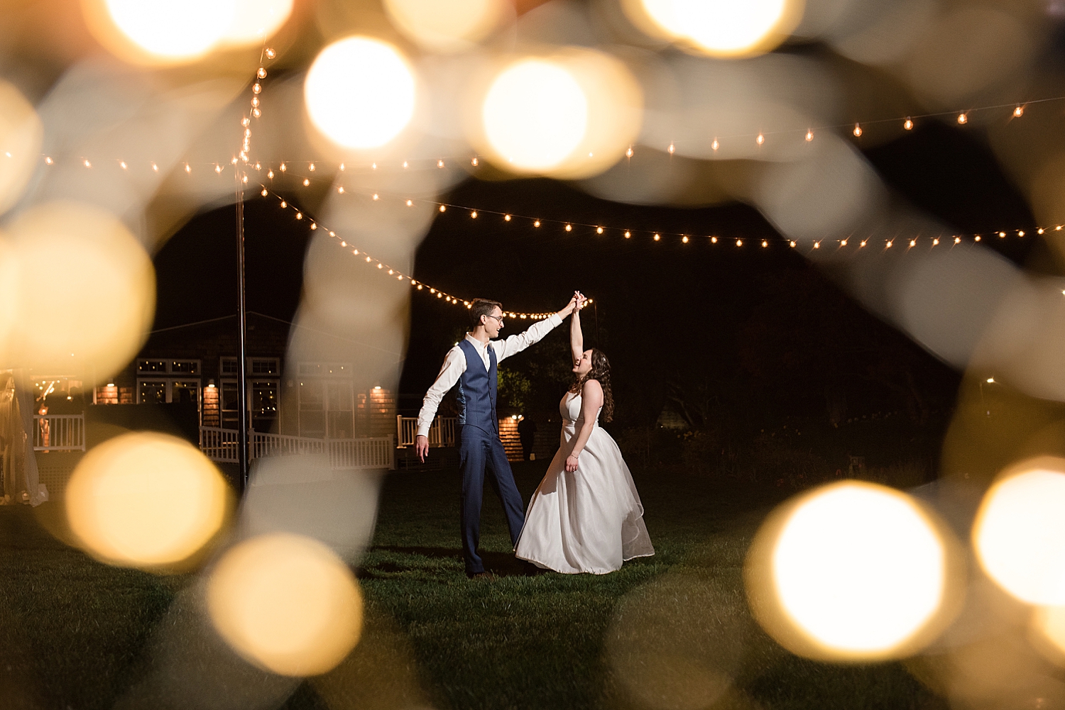 bride and groom spinning portrait, night shot with bokeh