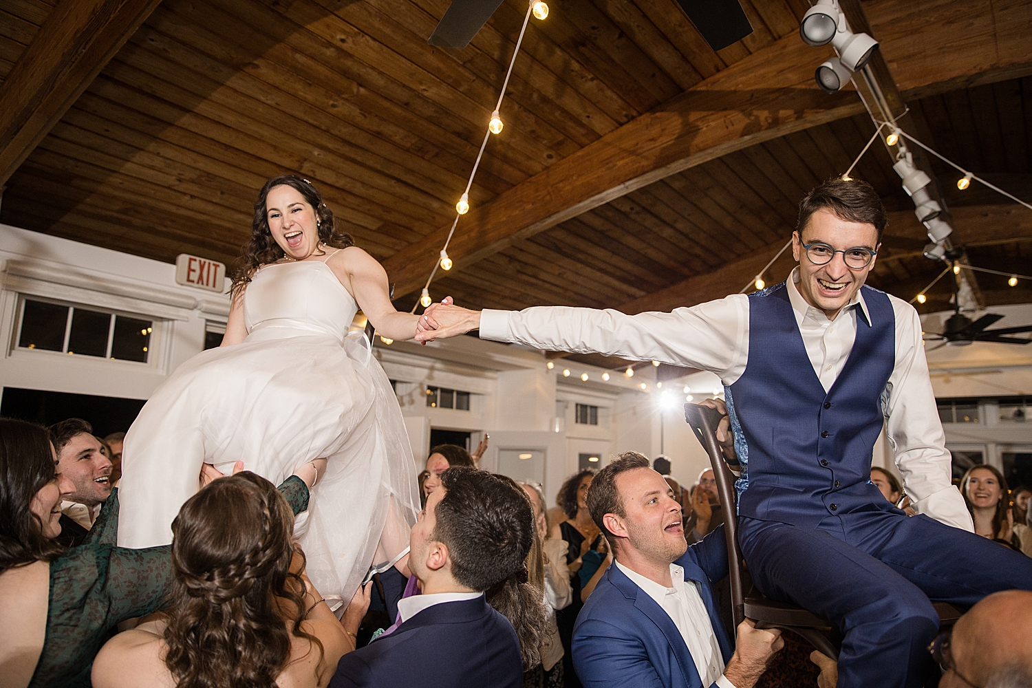 bride and groom lifted during horah