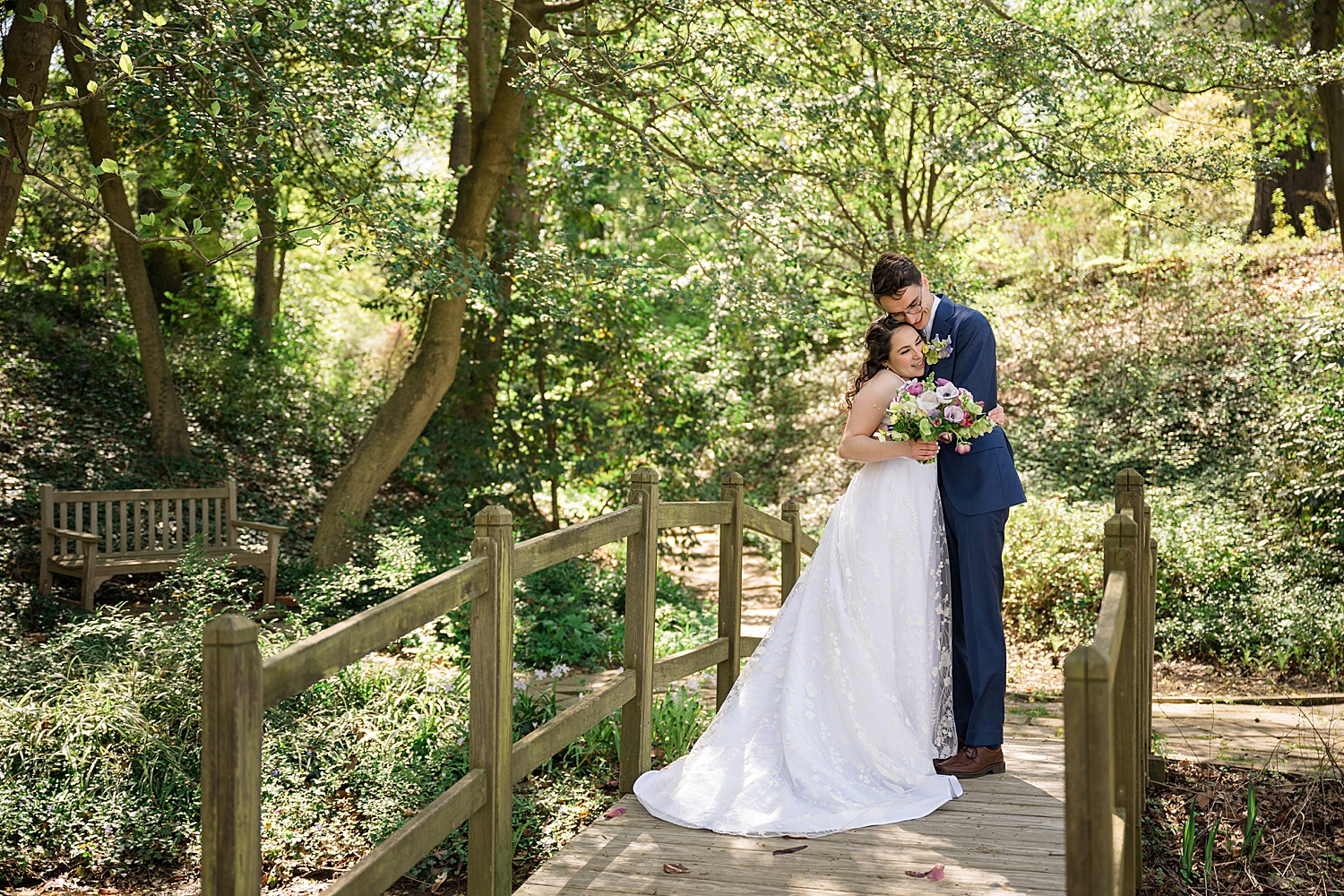 bride and groom on bridge among the trees