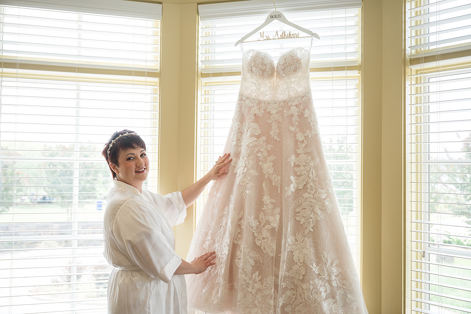 bride with hanging wedding dress