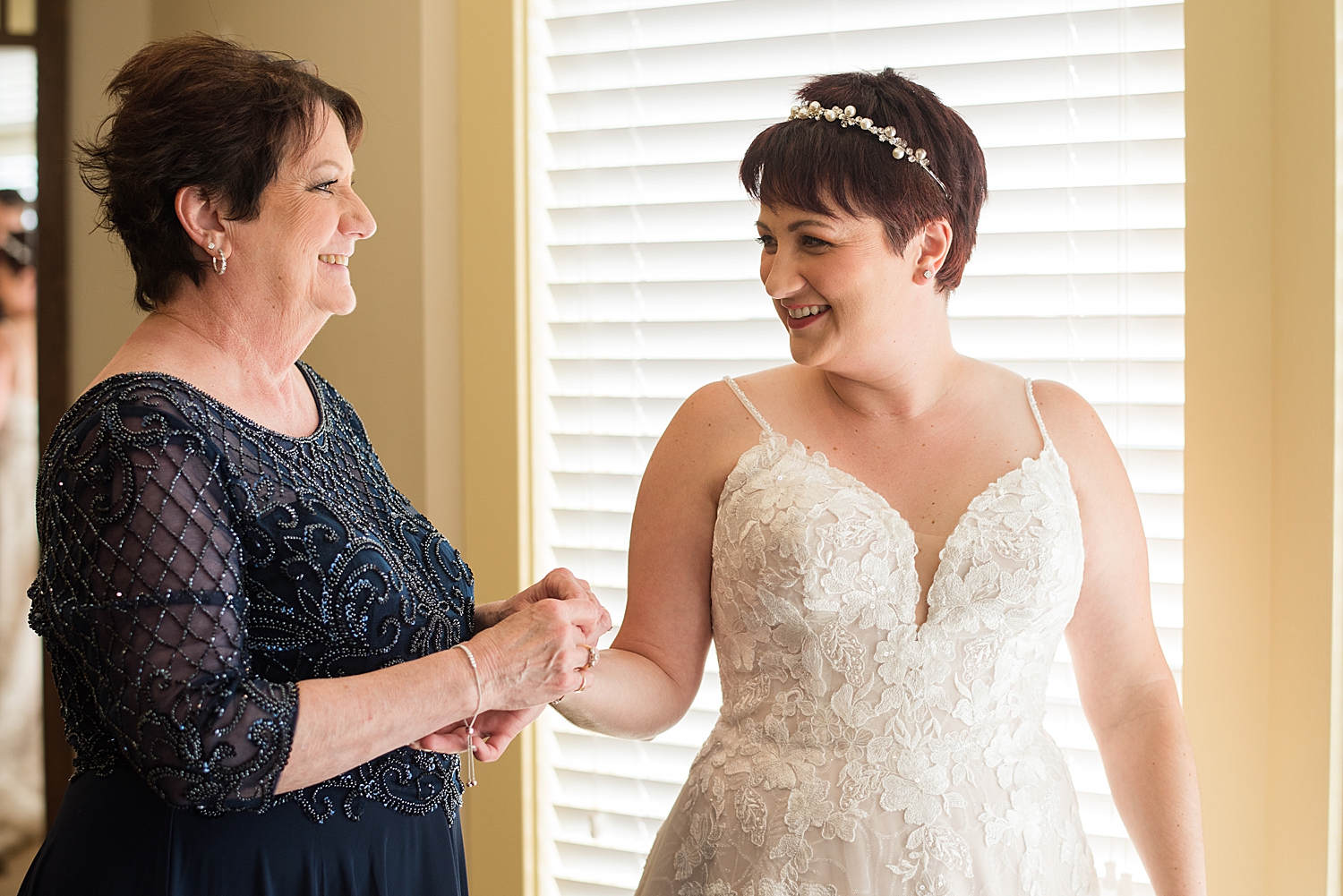 mom helping bride get dressed