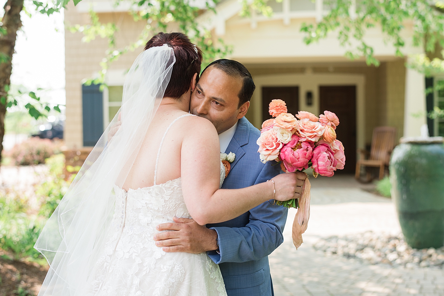 groom kisses bride's shoulder