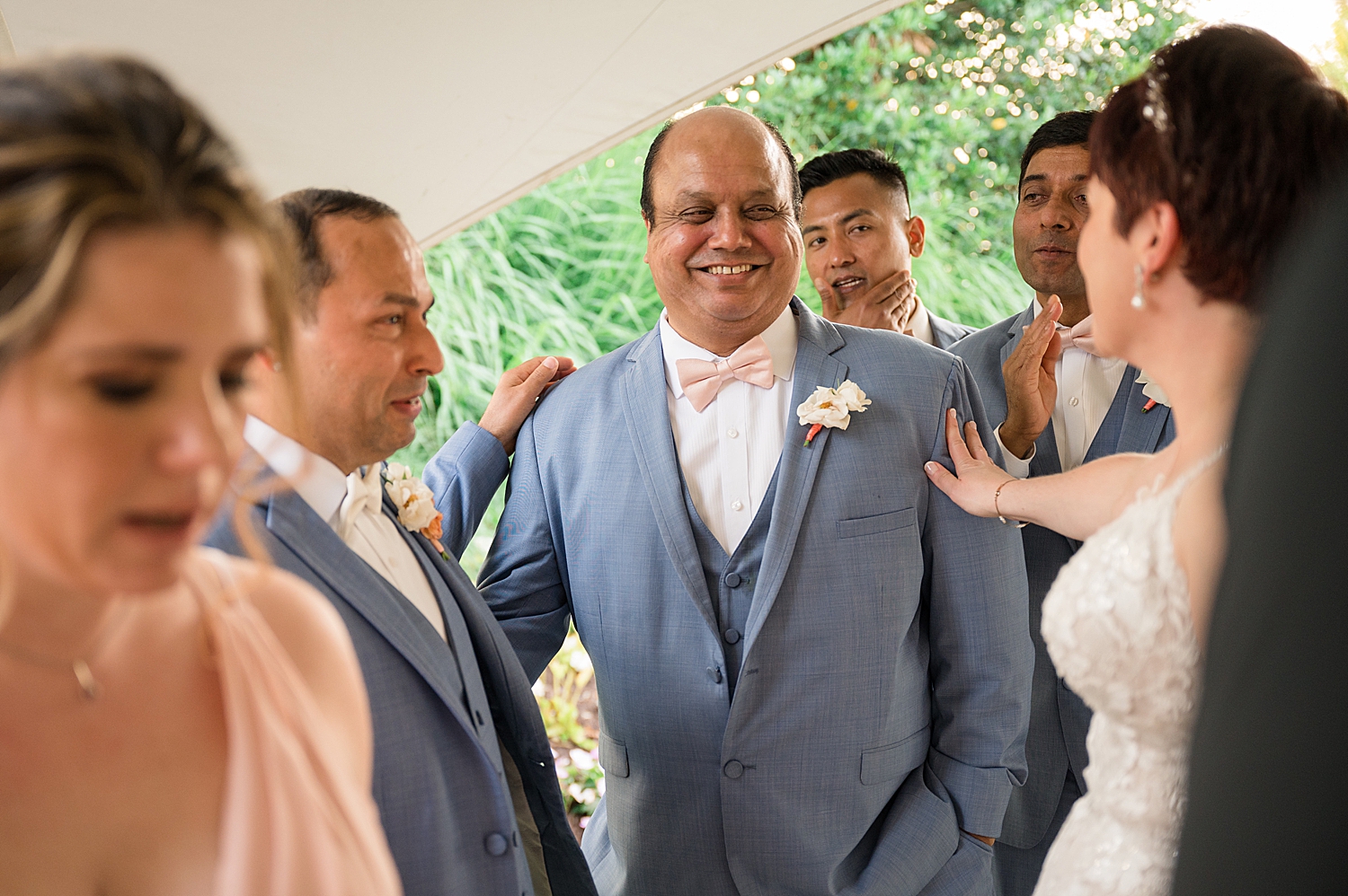 groom smiling with guests