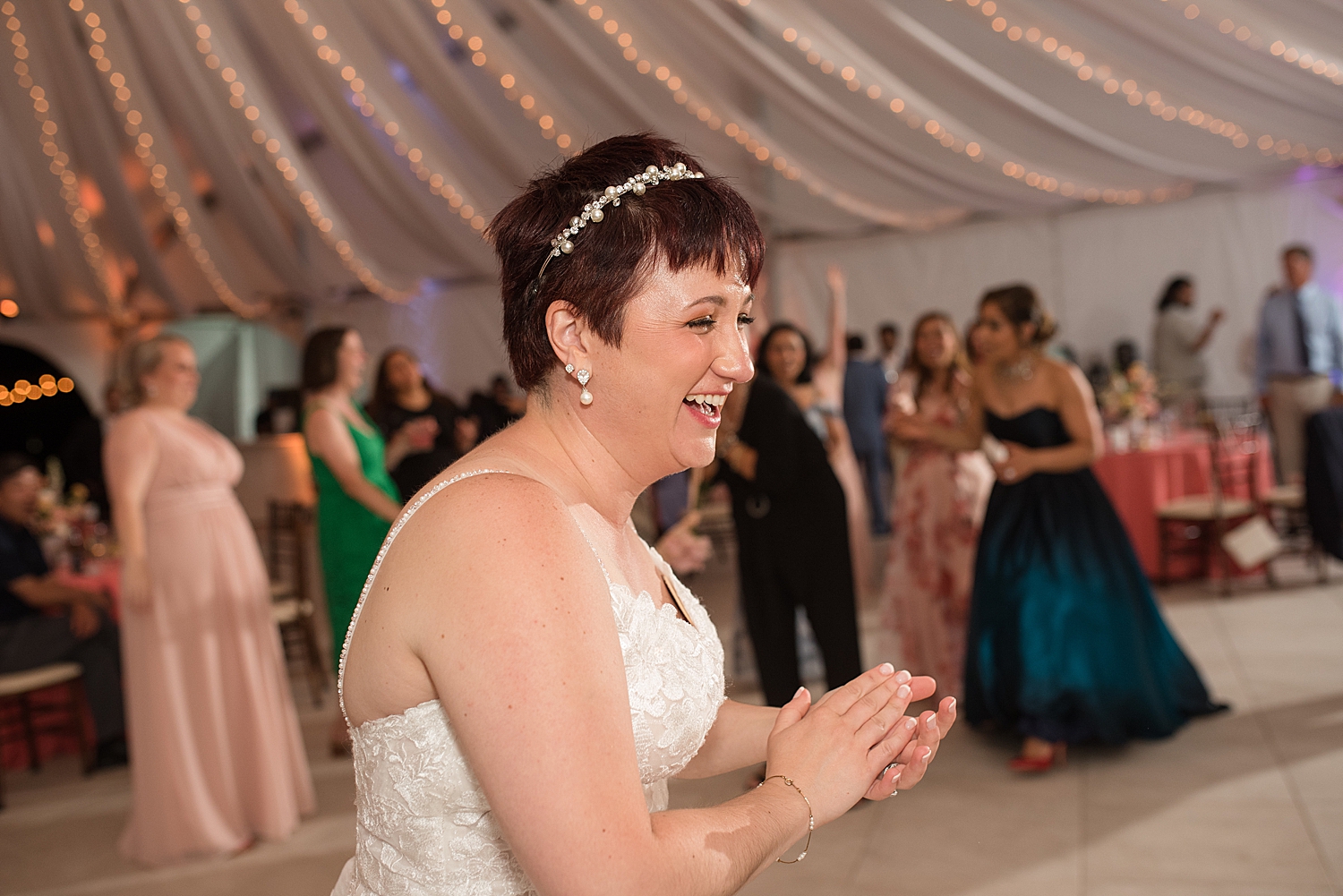 bride laughing after bouquet toss