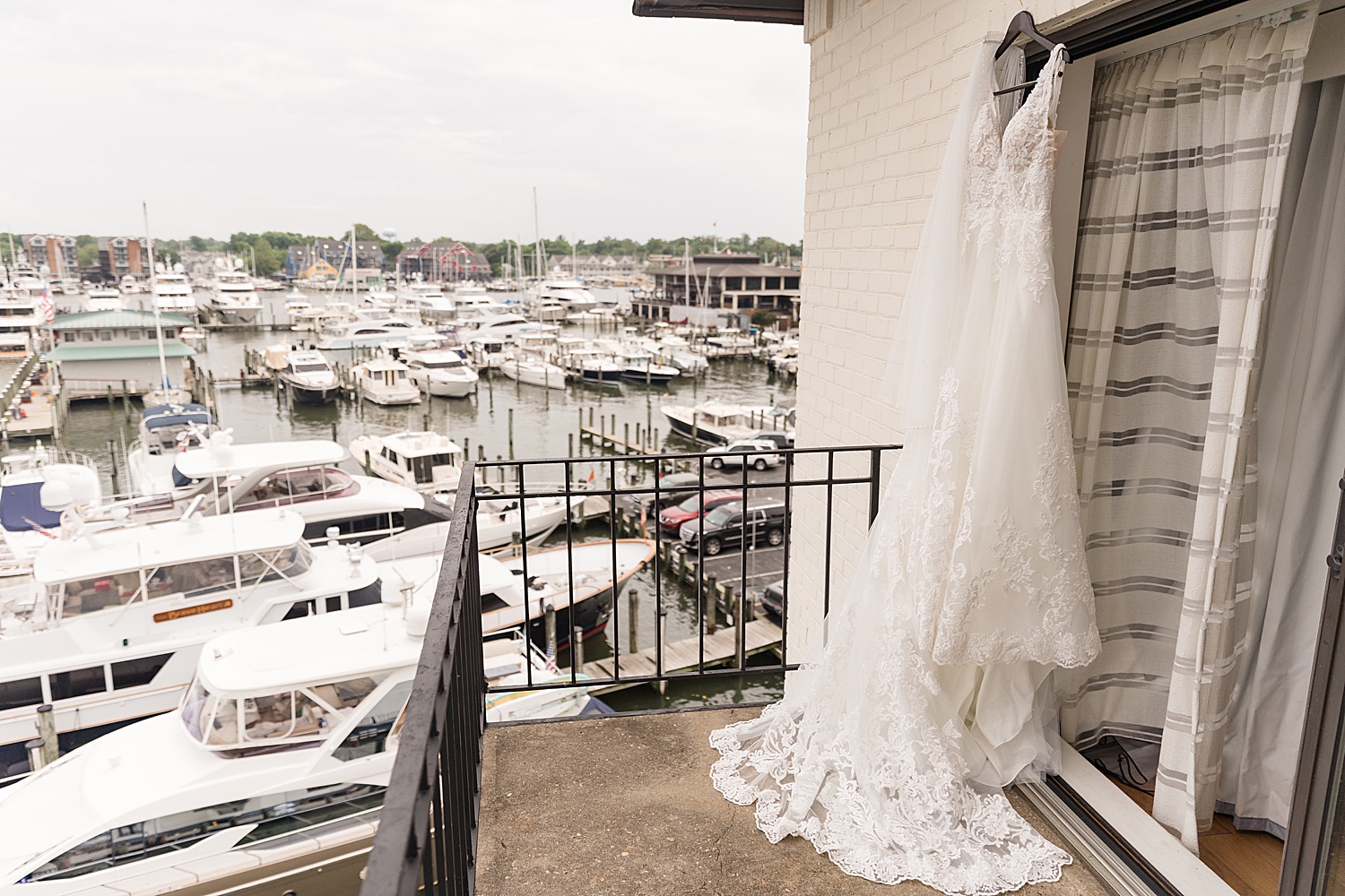 bride's dress hanging on balcony over ego alley in annapolis