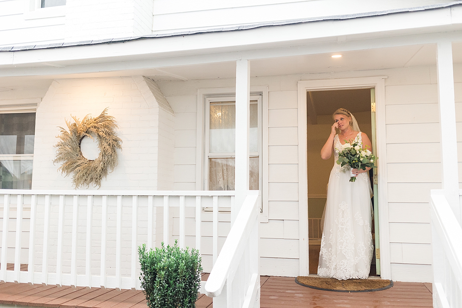 bride wiping tears getting ready for ceremony