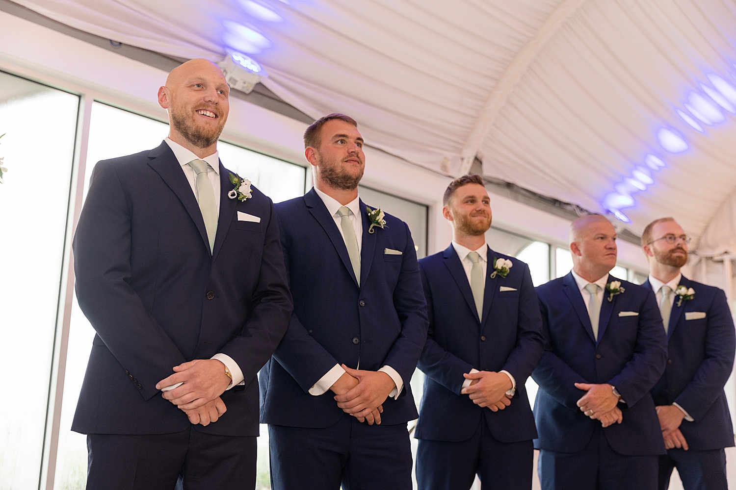 groom watches bride enter ceremony