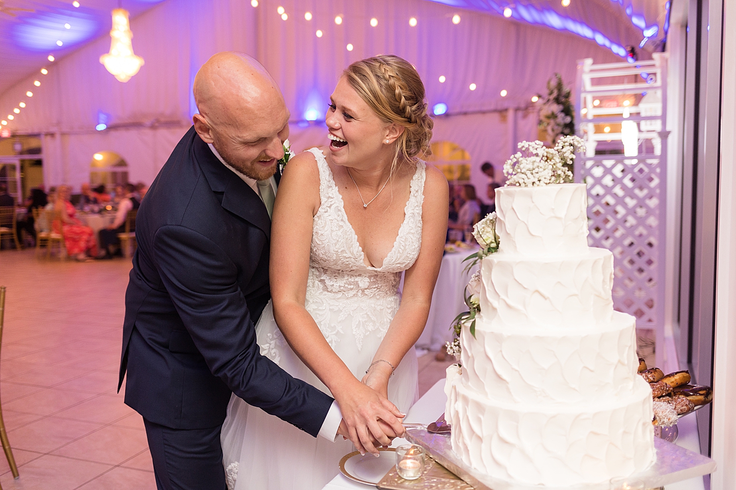 bride and groom joyful cake cutting