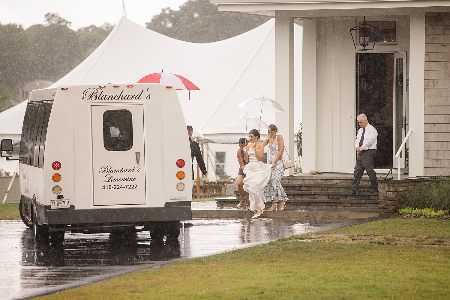 bride makes her way to transportation in the rain