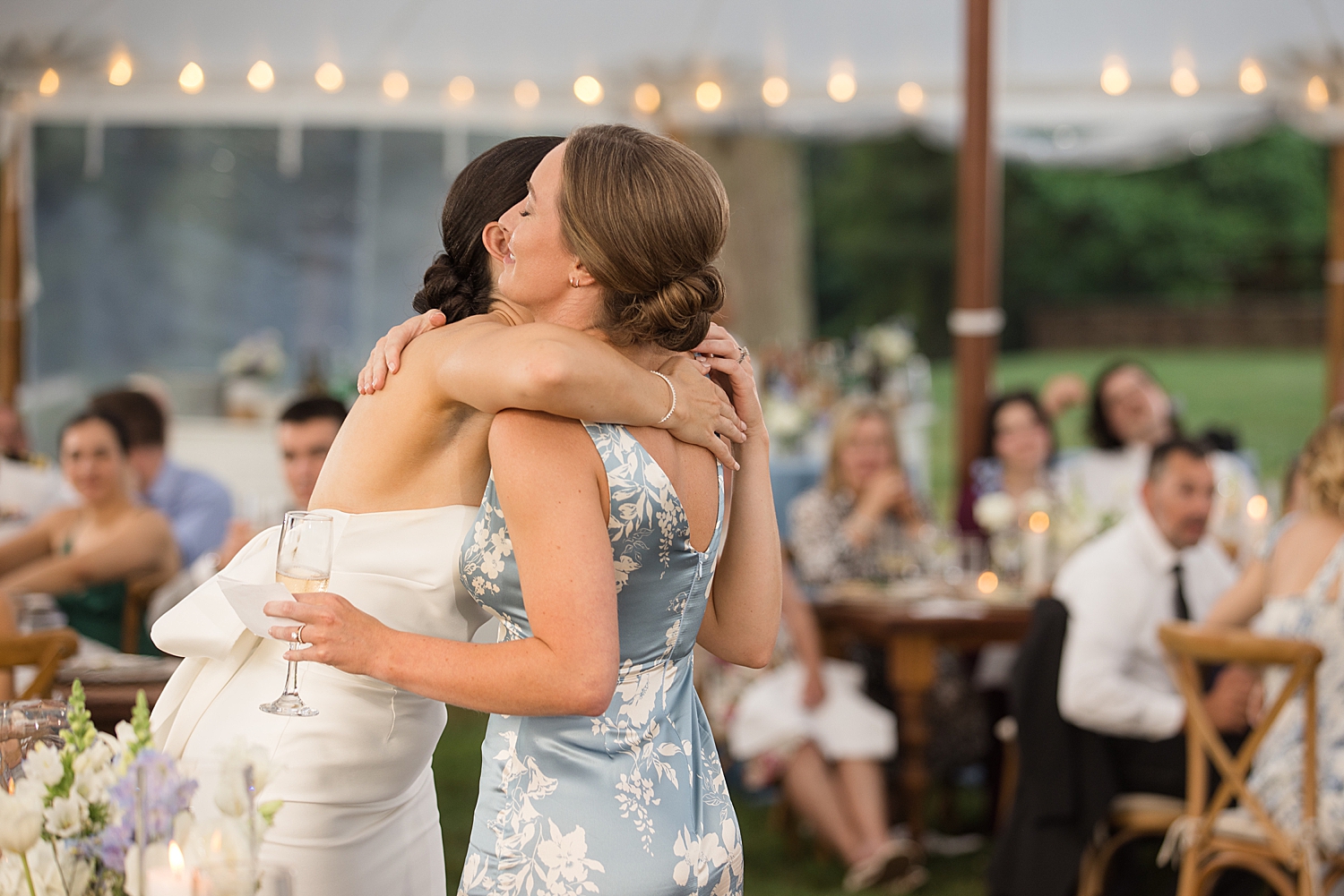 bride hugging maid of honor after speech