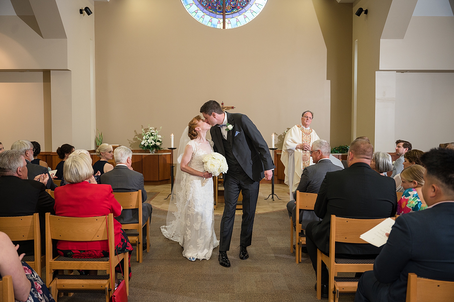 bride and groom kiss before recessional