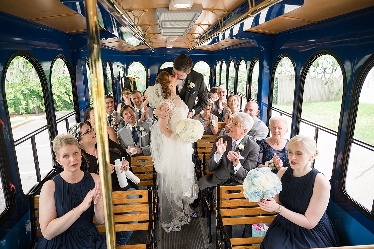 bride and groom kiss on trolley