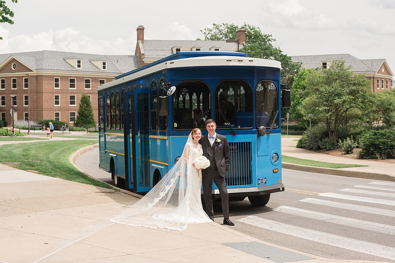 bride and groom portrait in front of blue trolley