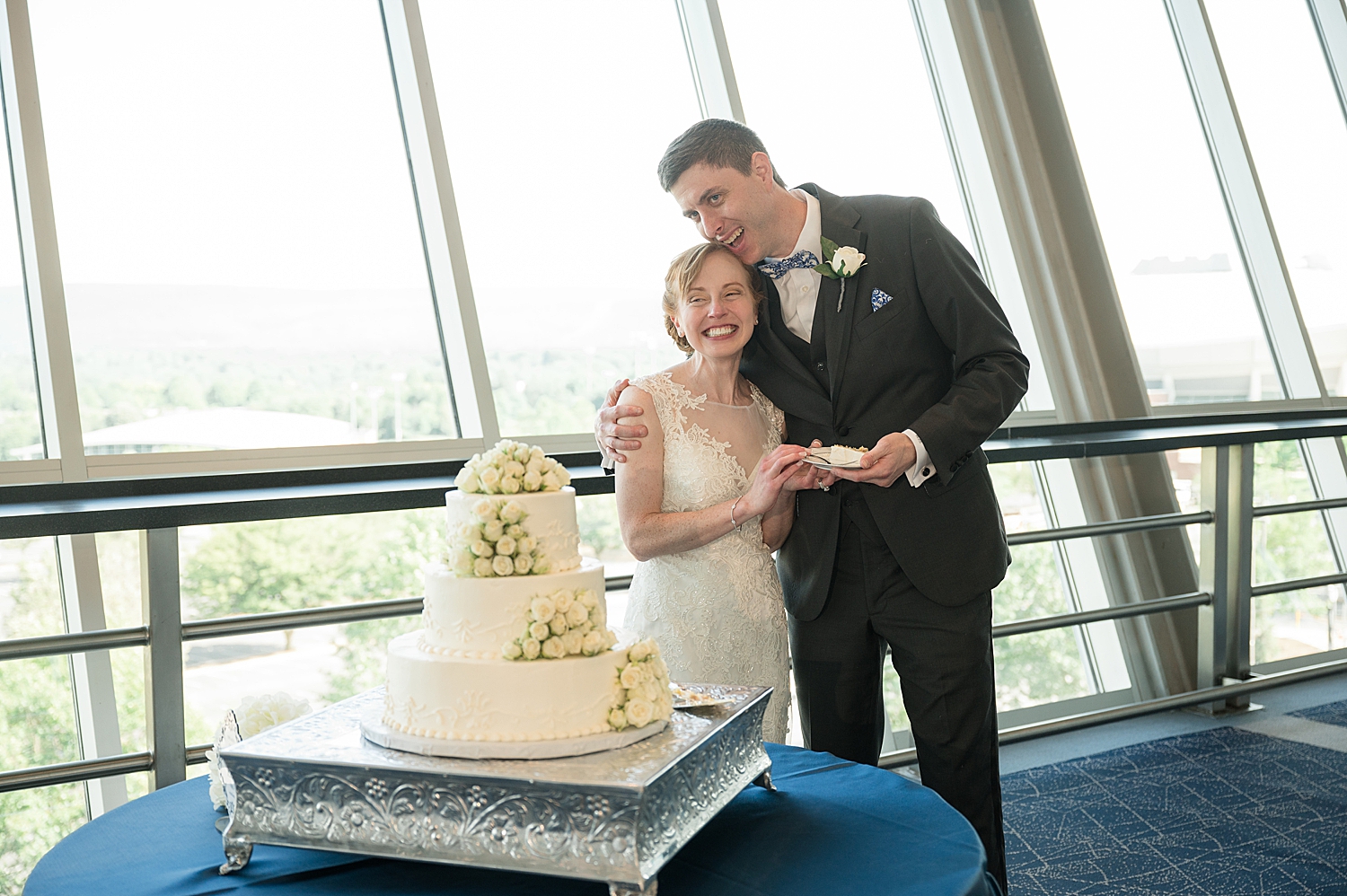 bride and groom cut cake