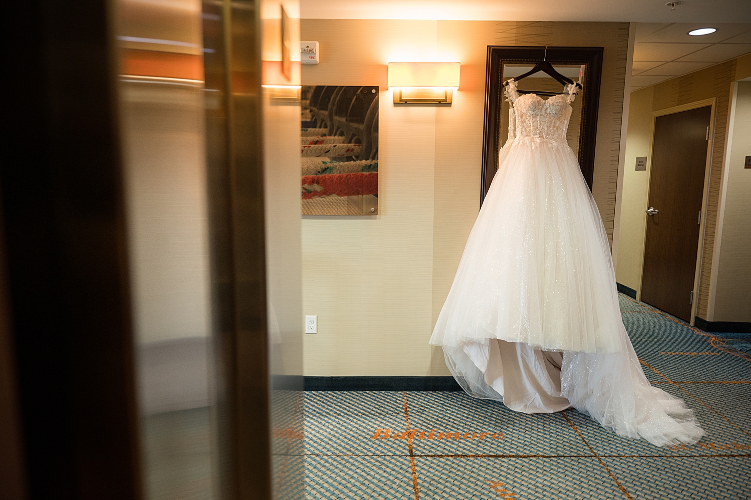 bridal gown hanging in hallway