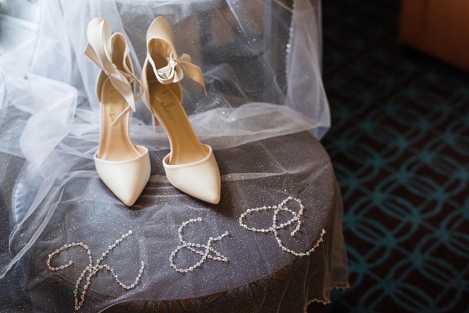 detail shot of embroidered veil and wedding shoes