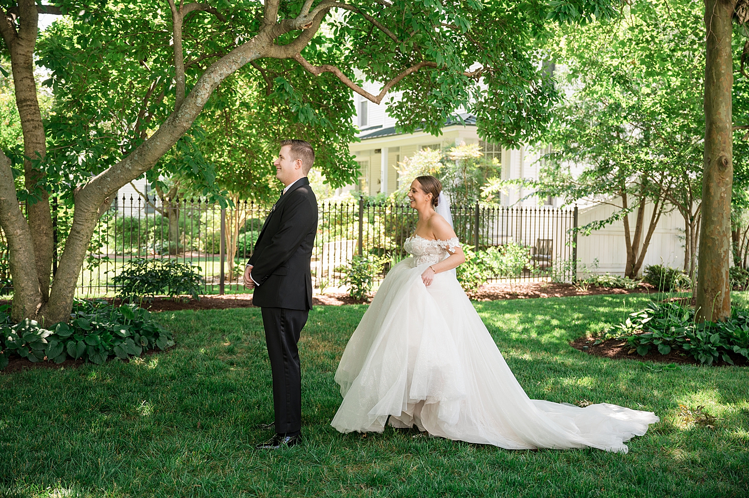 bride and groom first look under green trees