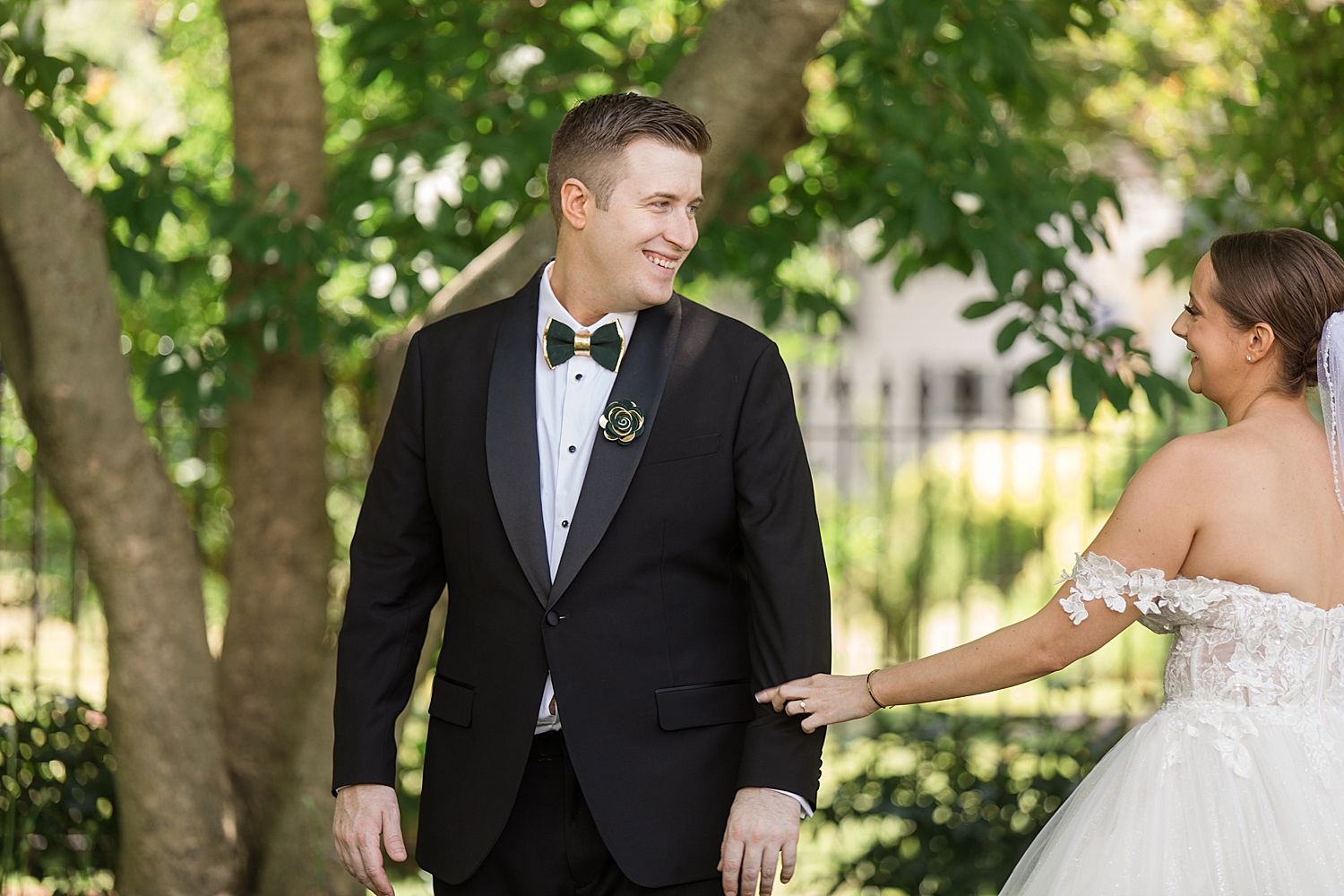 bride and groom first look under green trees