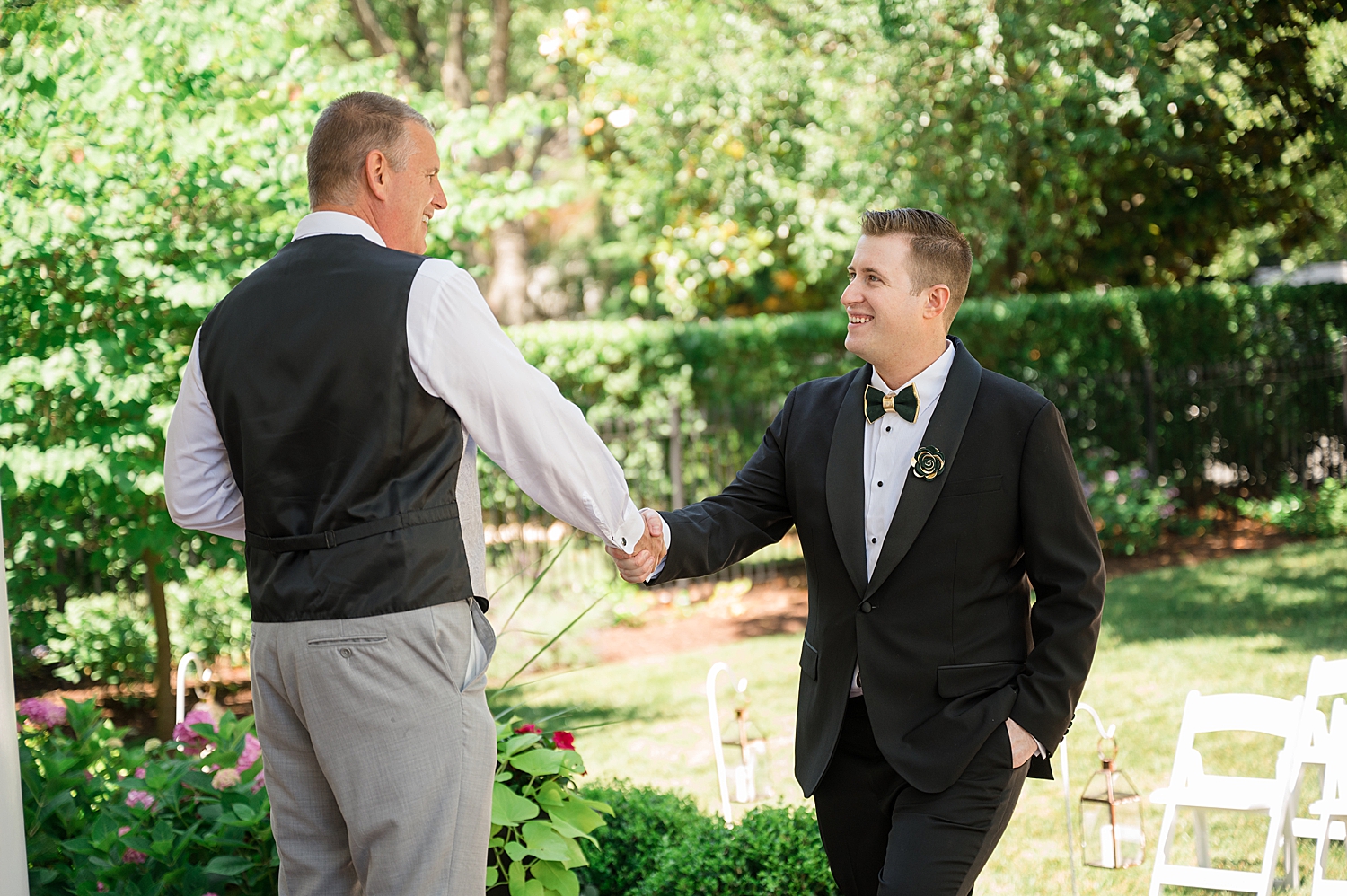 groom shakes hand of guest