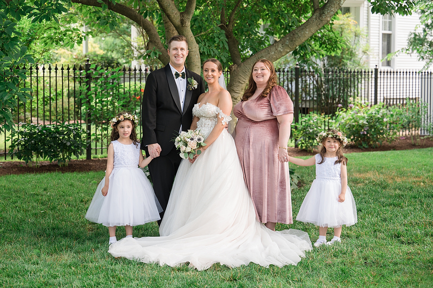 bride and groom with family, flower girls