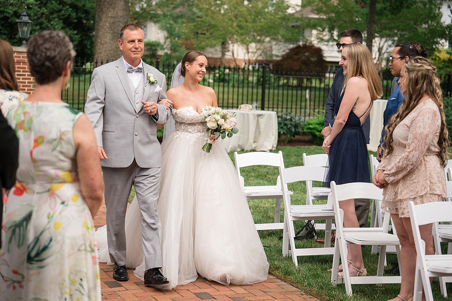 bride walks down the aisle with her dad