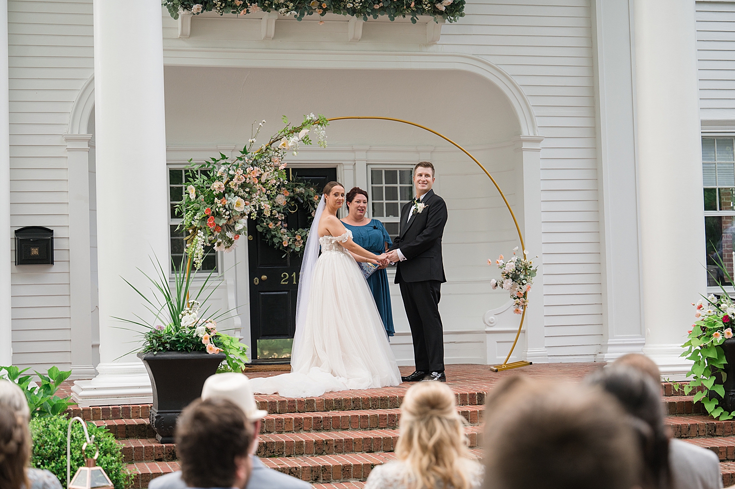 bride and groom look out at all their guests