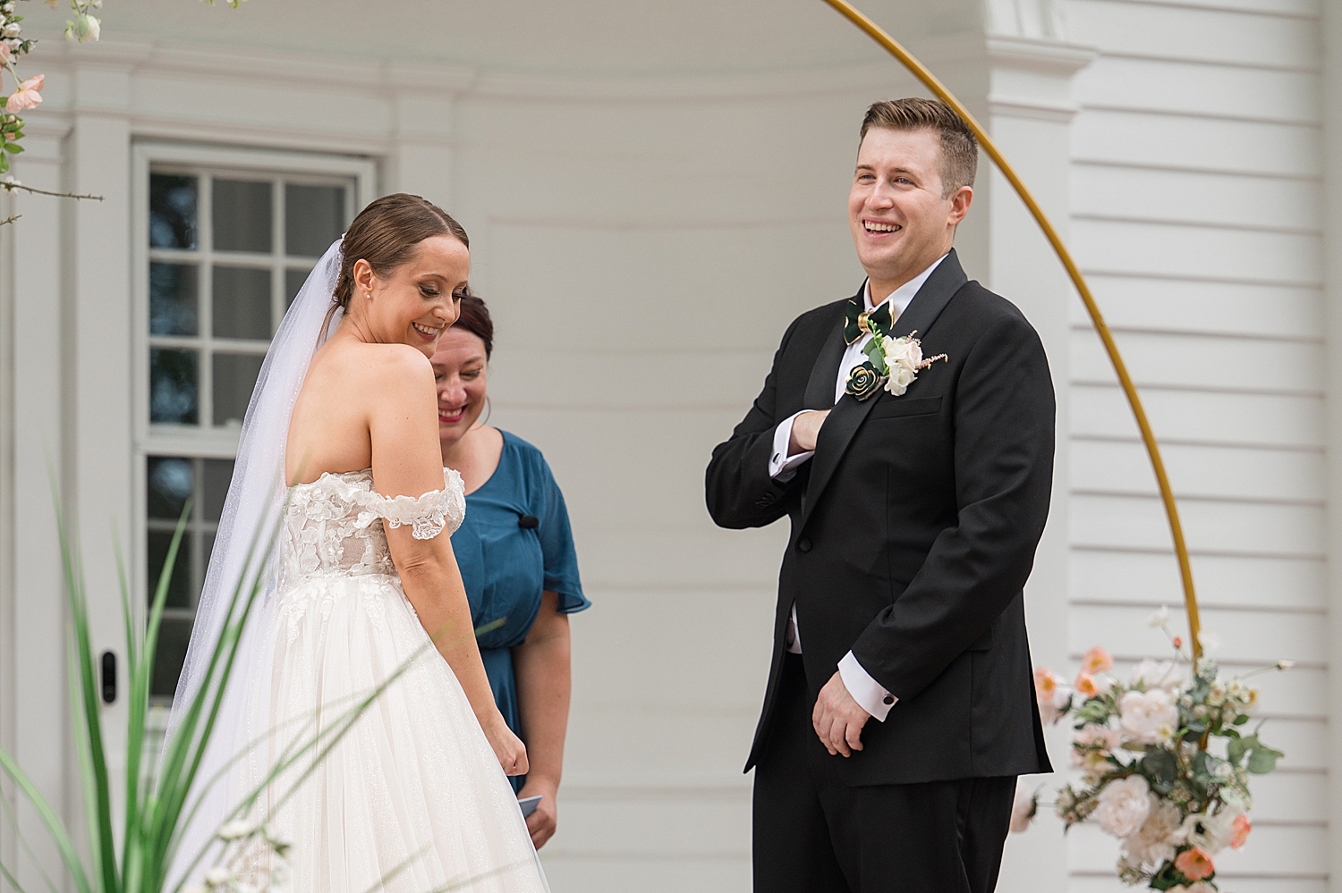 bride and groom smile during wedding ceremony