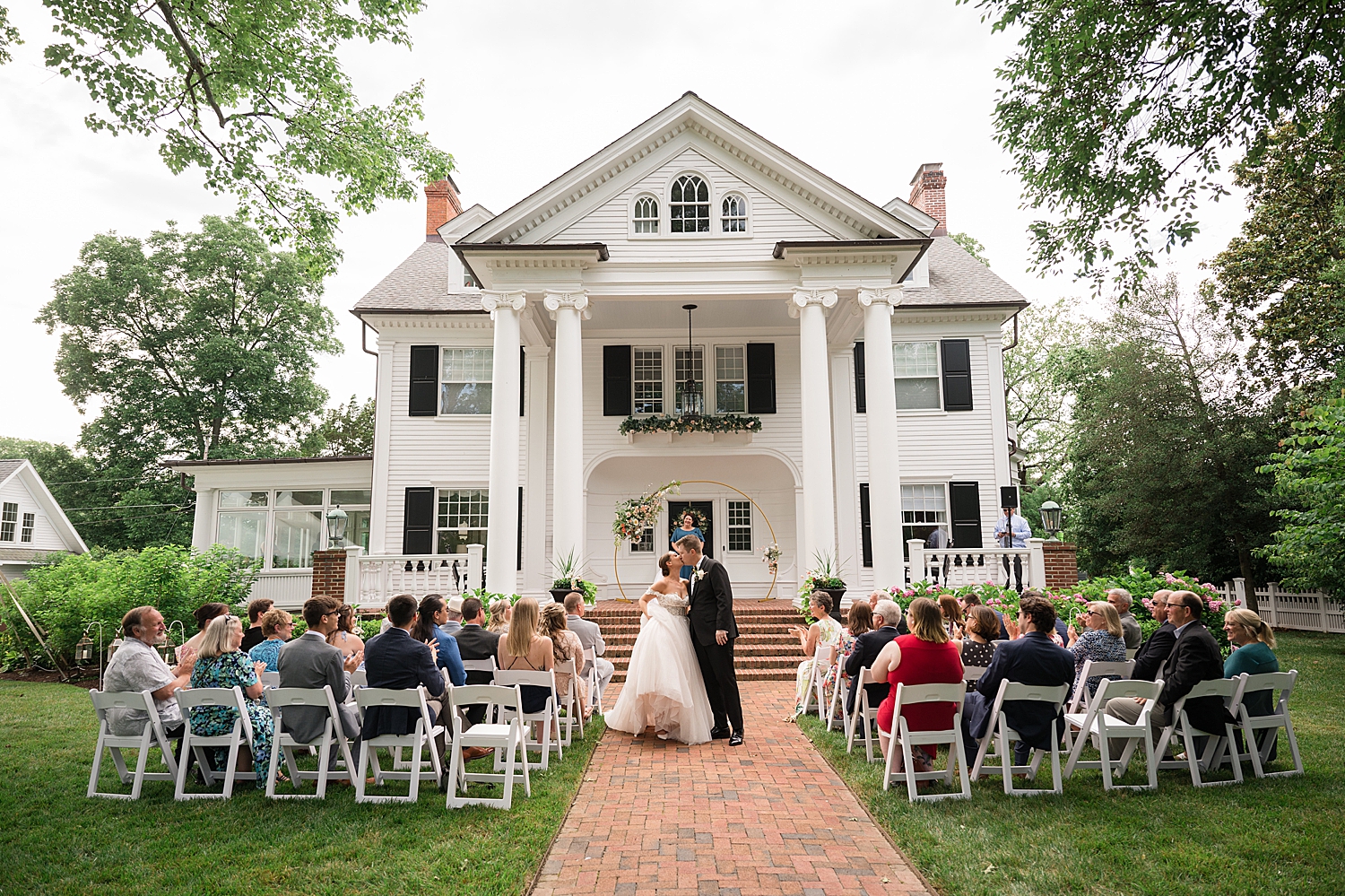 bride and groom kiss in the aisle after ceremony