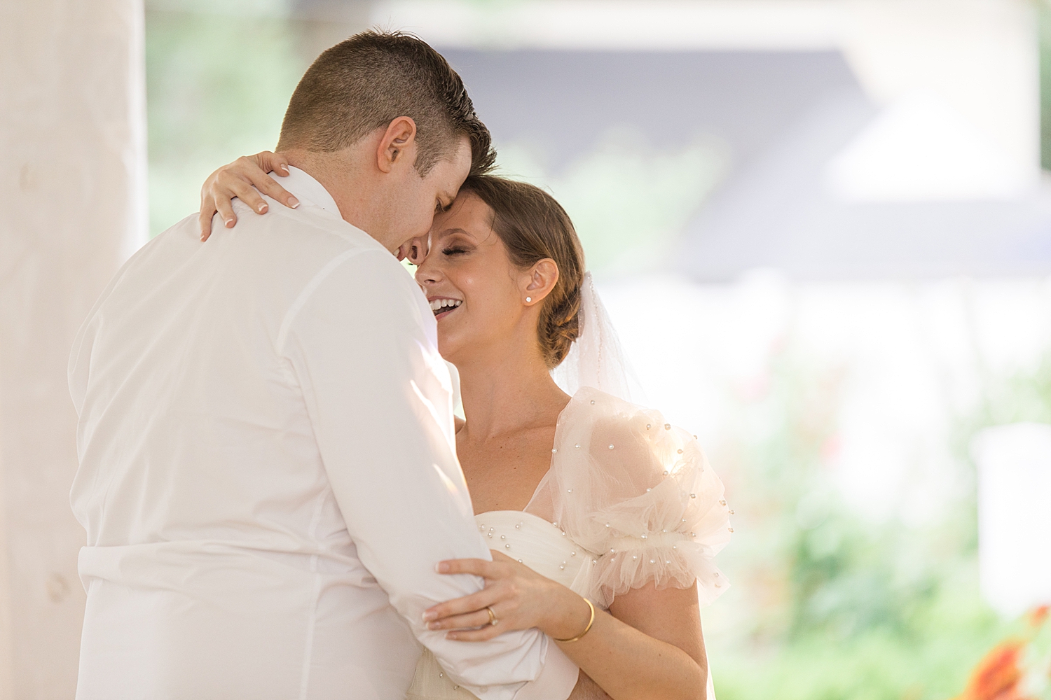 bride and groom rest their foreheads together during first dance