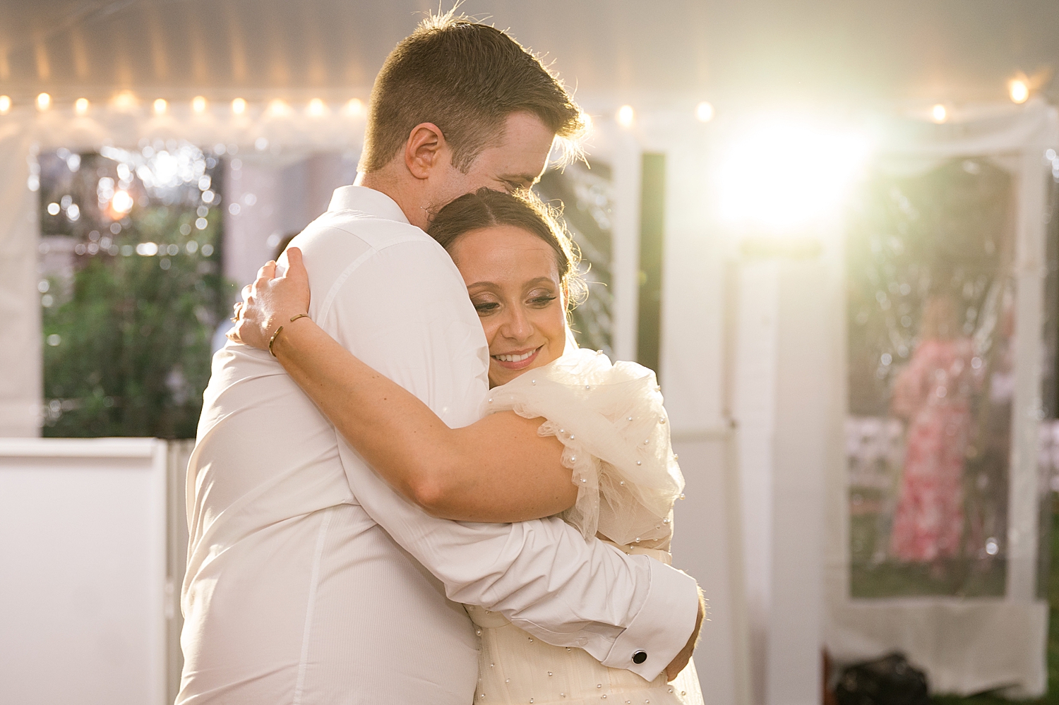 bride and groom embrace on dance floor