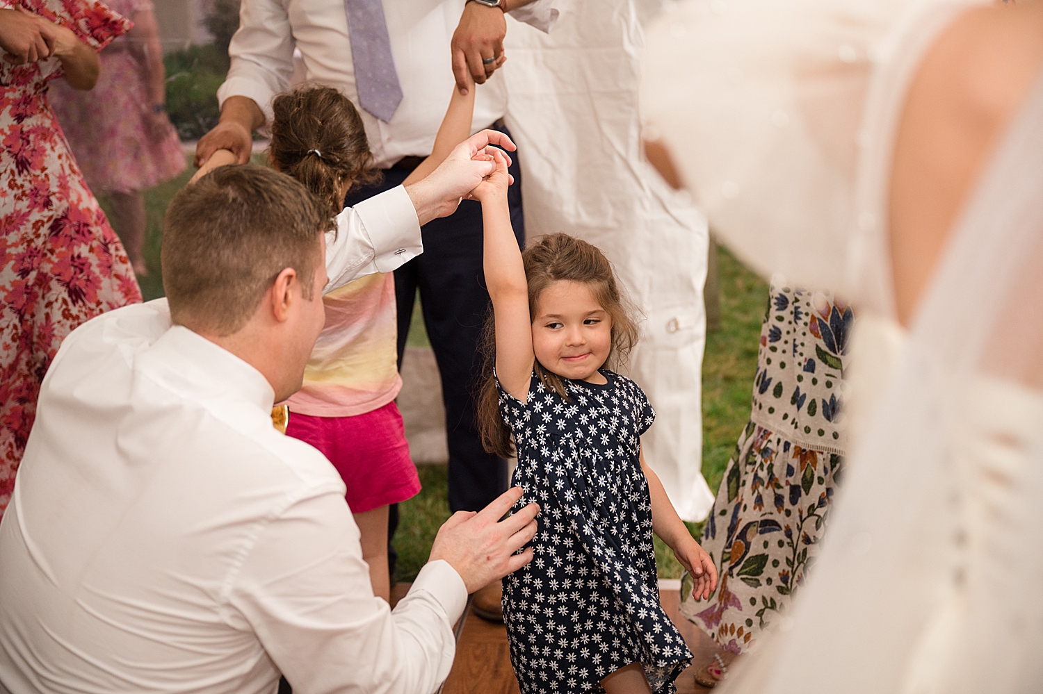 candid guests dancing at tented reception