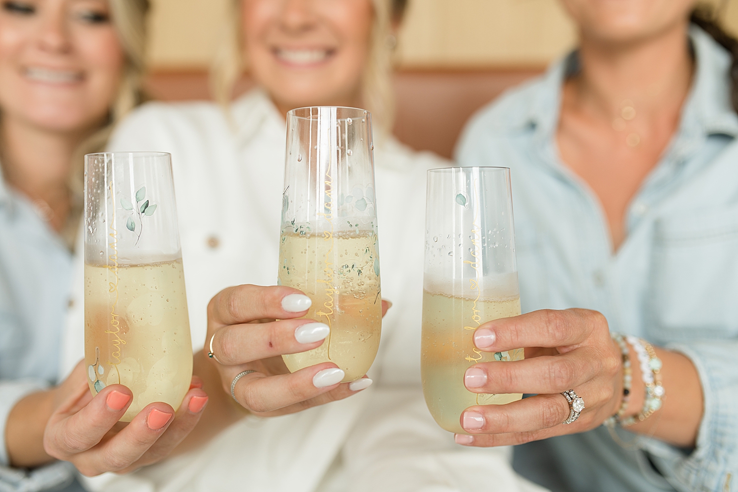 bride and bridesmaids toast with champagne