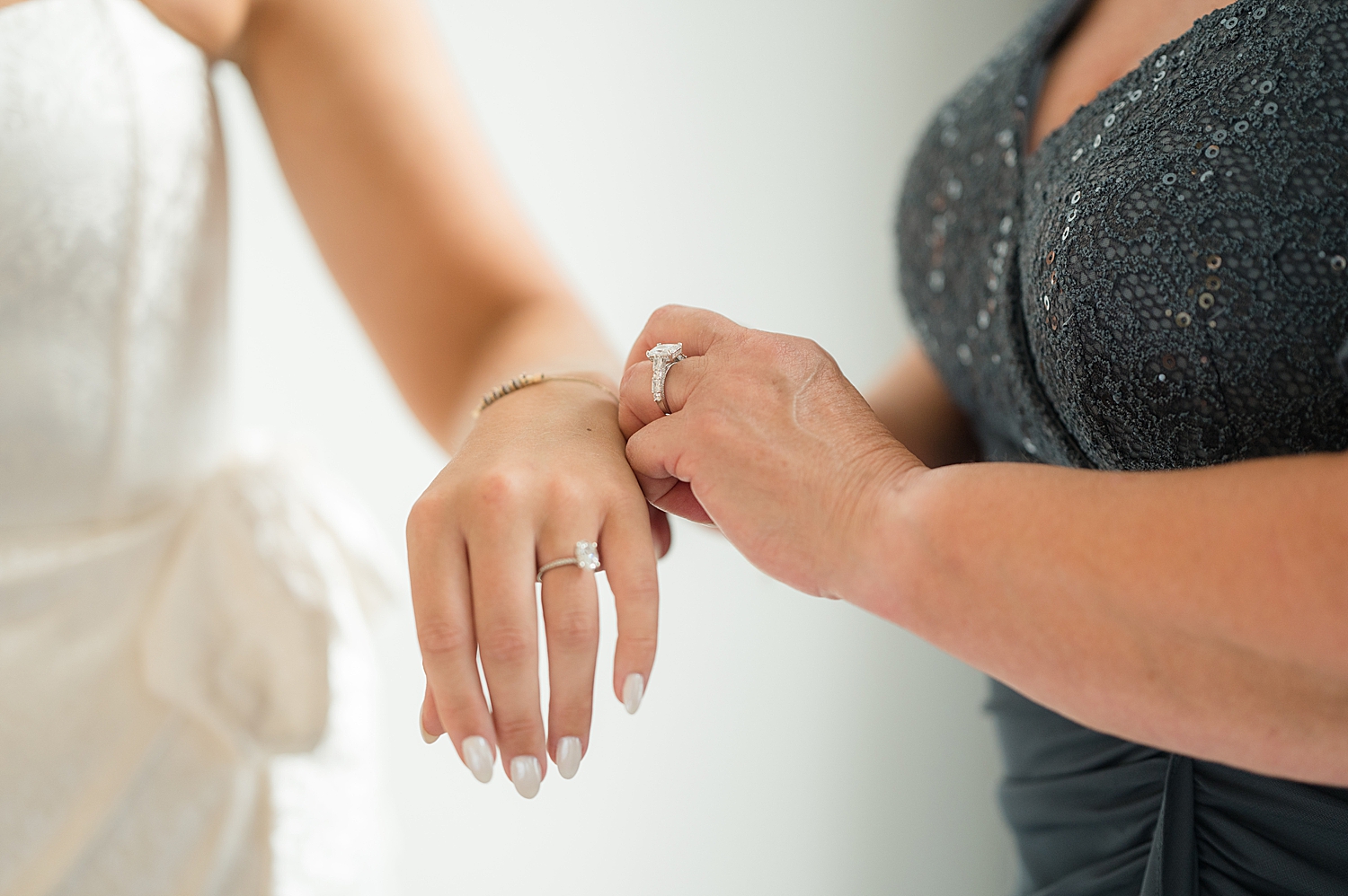 bride's mom helps with bracelet