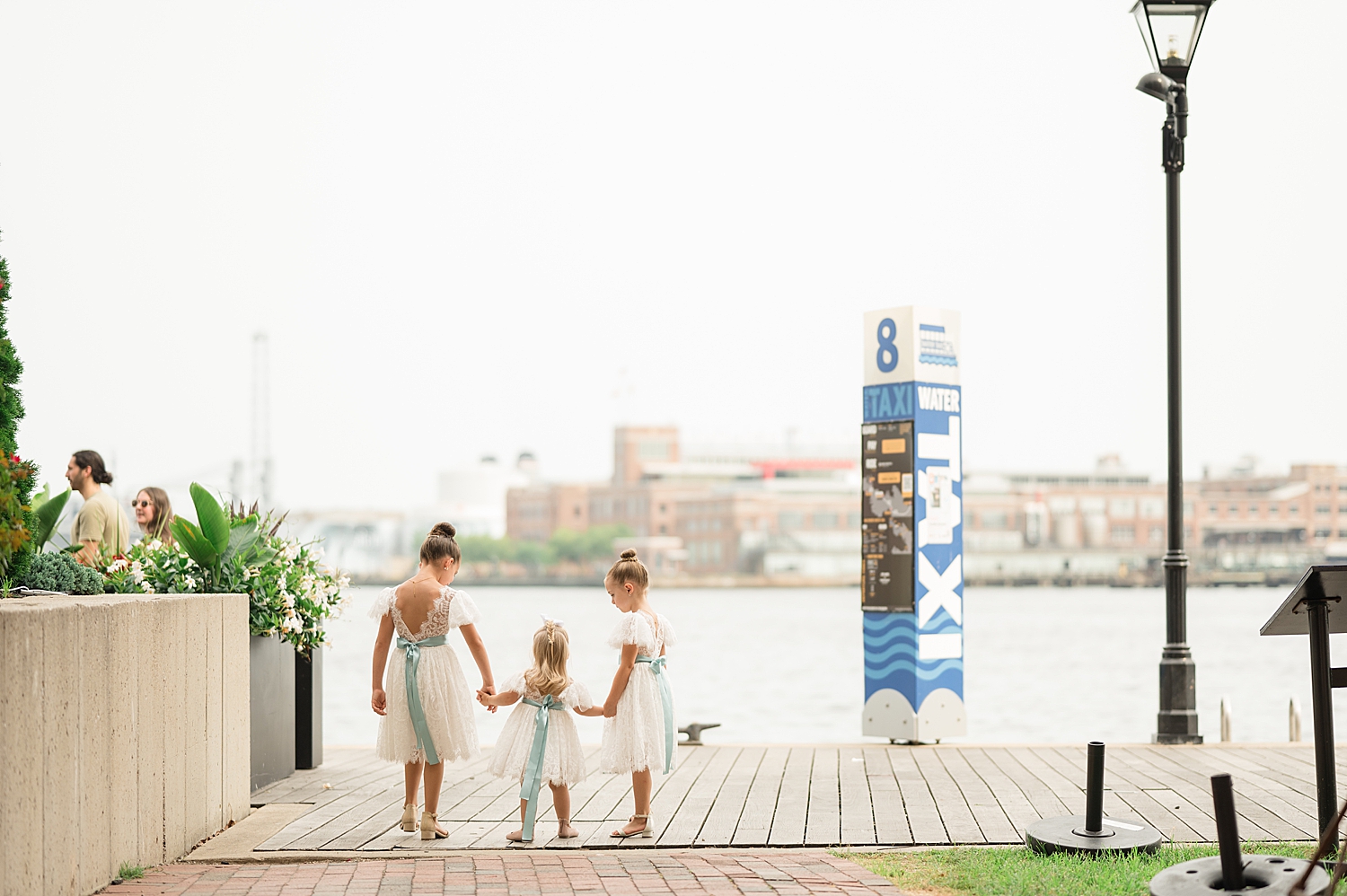 wide shot of three flower girls holding hands