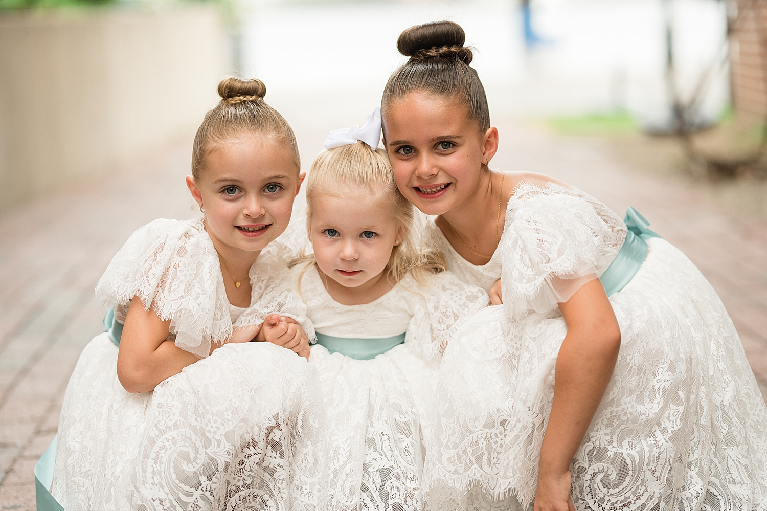 flower girls smiling in white dresses