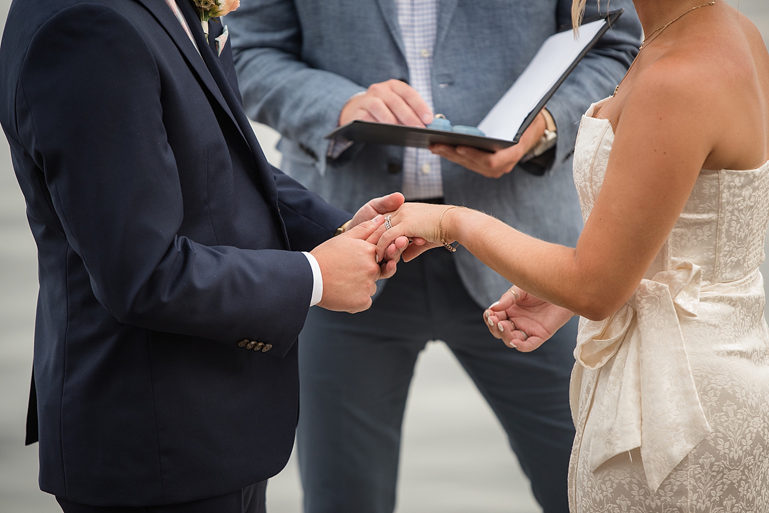 bride and groom exchange rings baltimore waterfront