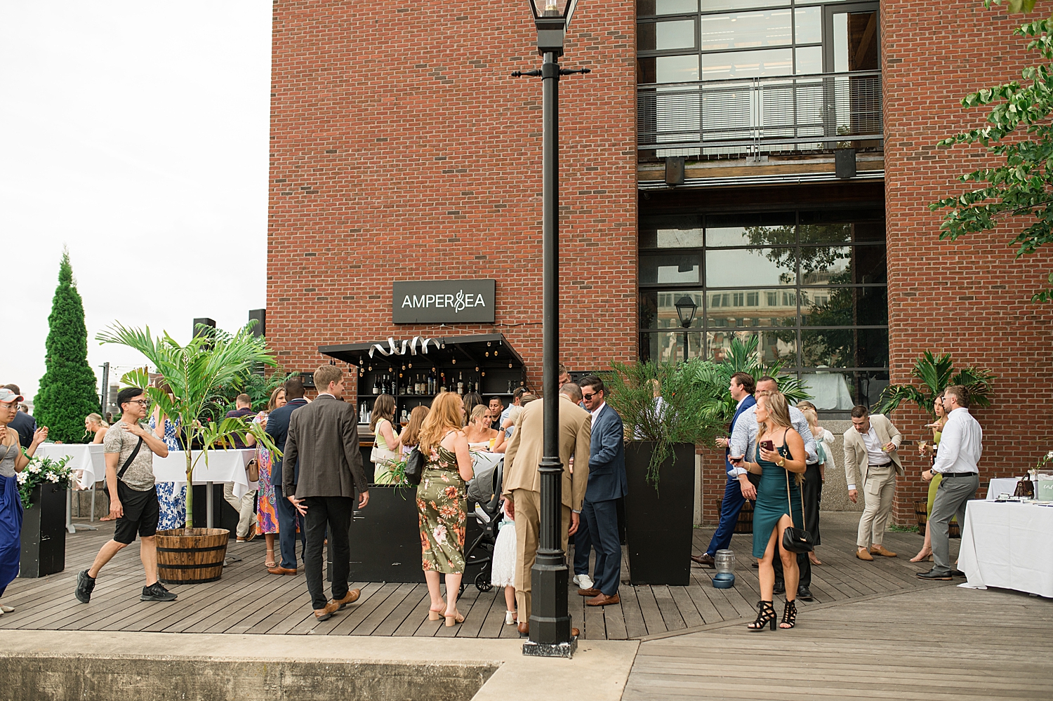 wedding guests gather at Ampersea for cocktail hour