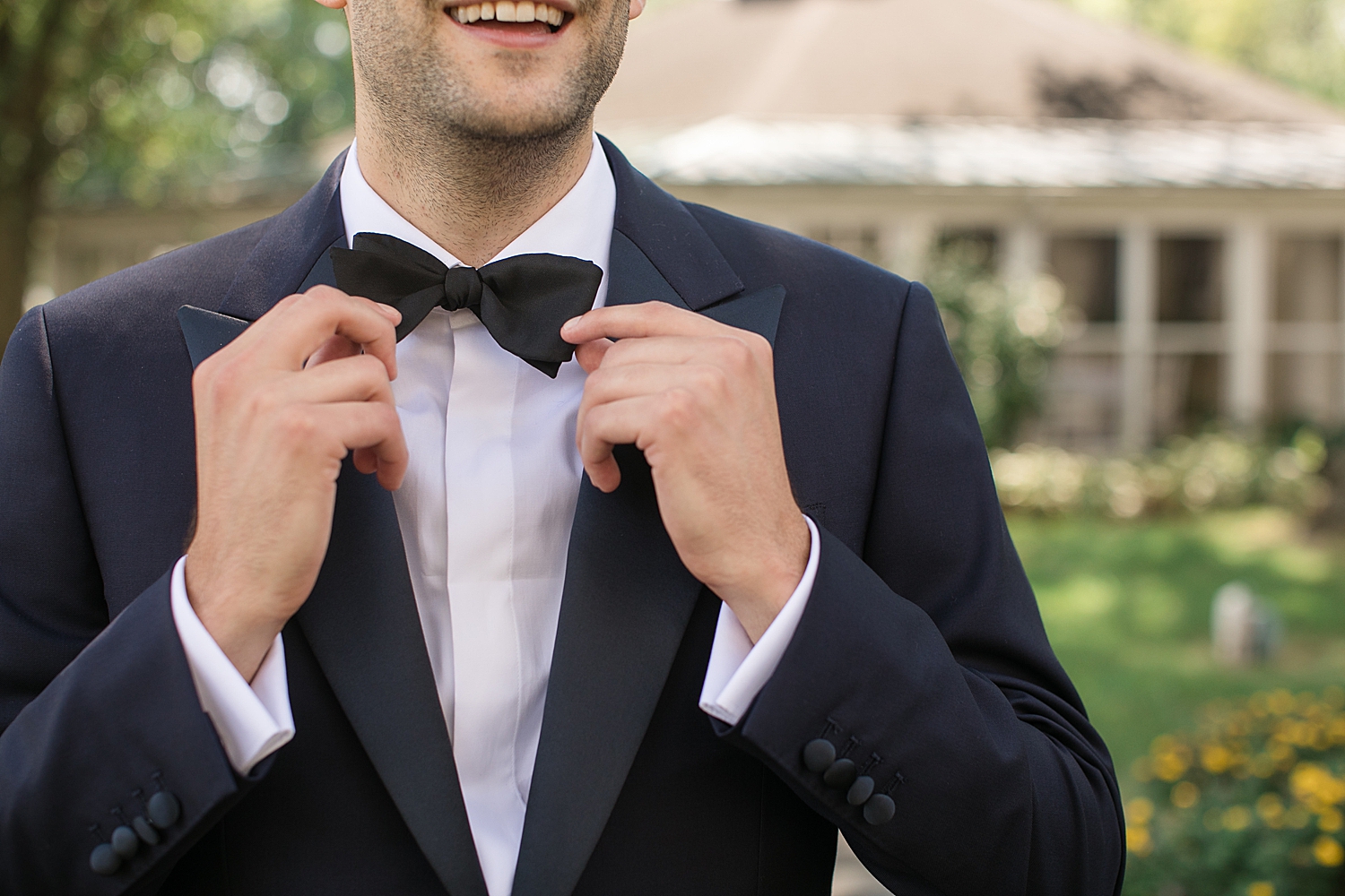 groom fixing bow tie