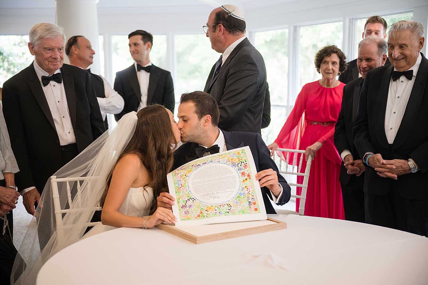 bride and groom sign the ketubah ahead of jewish ceremony